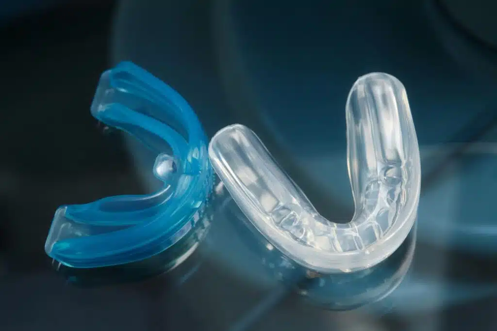 Woman holding a blue mouth guard – Do mouth guards help with snoring?