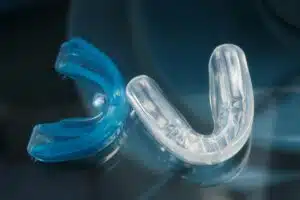 Woman holding a blue mouth guard – Do mouth guards help with snoring?