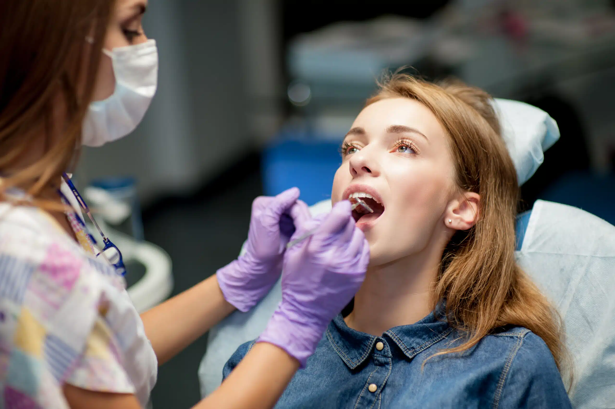 Orthodontist checking lingual braces during appointment in Gallup NM